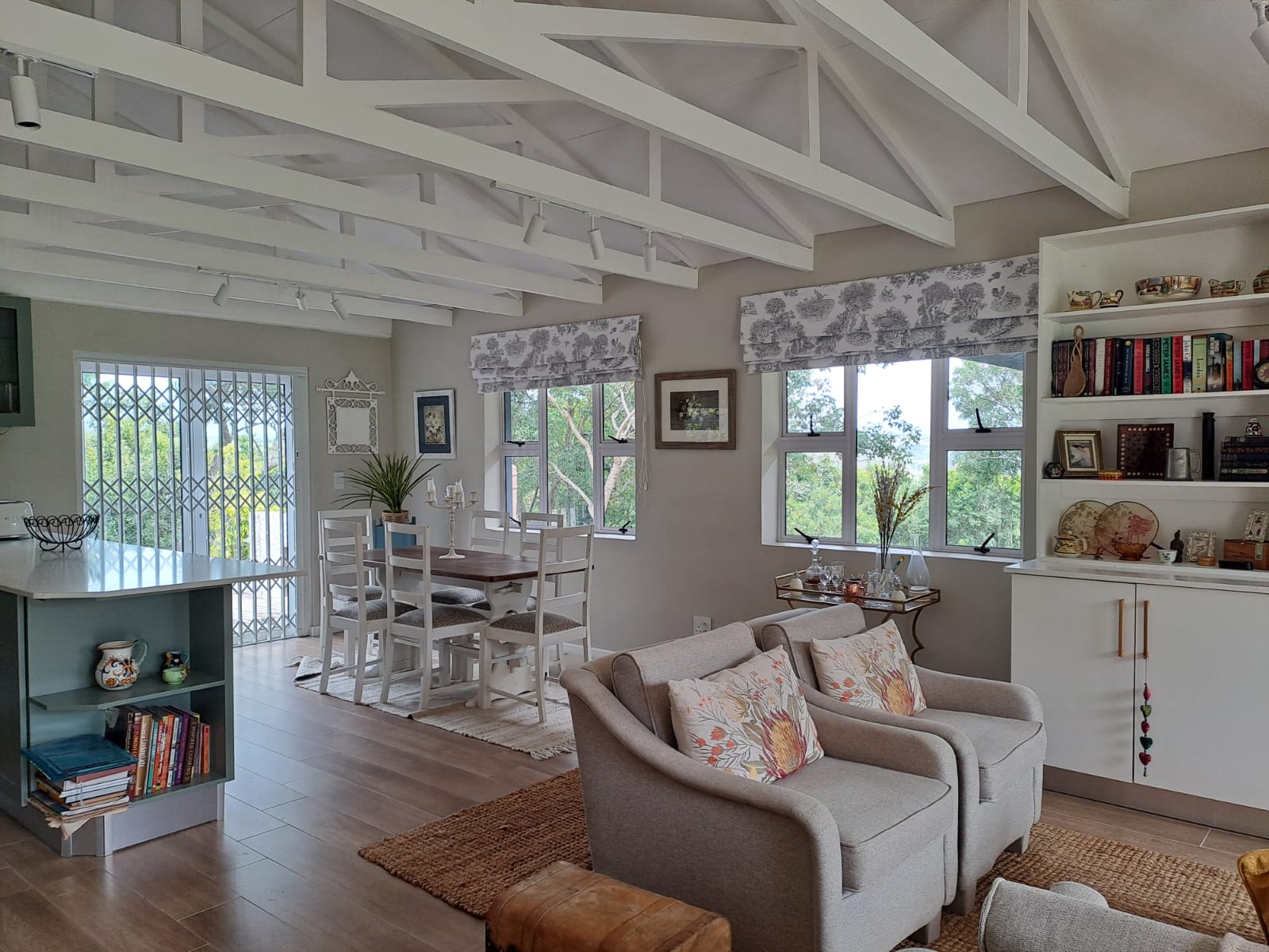 Open-plan living and dining with exposed trusses