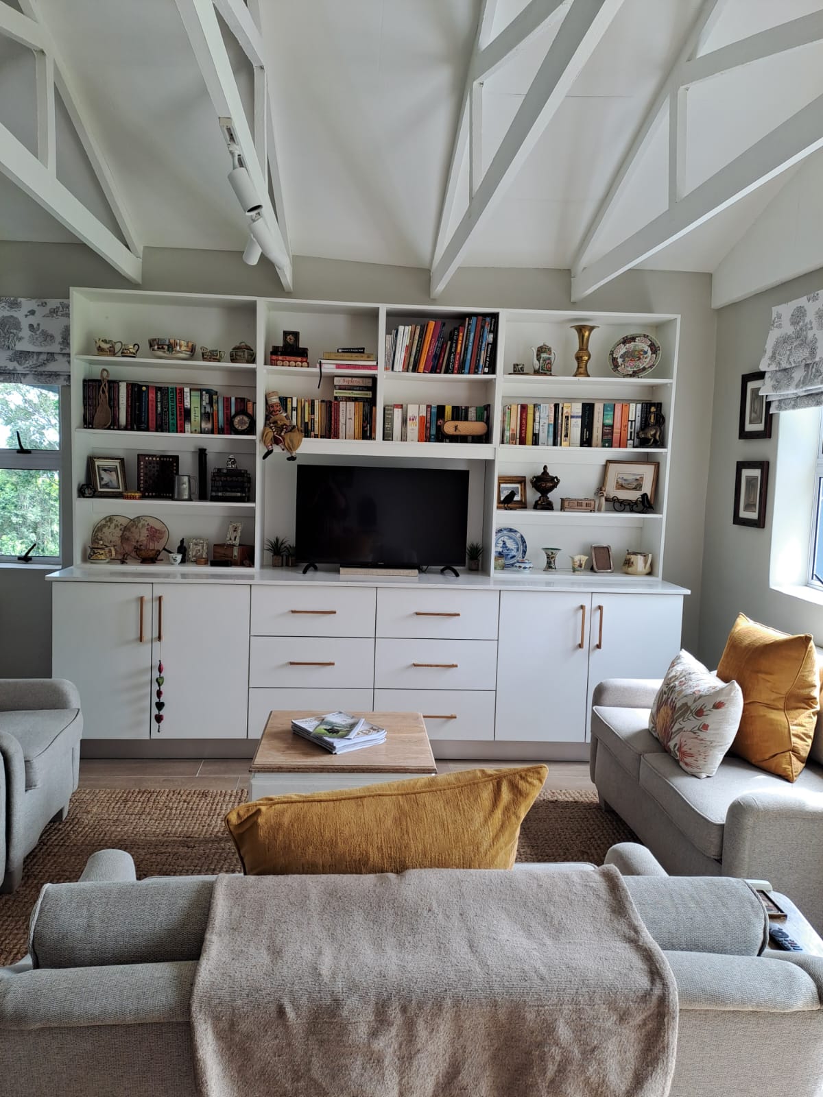 Living area with bookshelf wall and smart TV